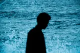 Silhouette d'un homme devant la mer bleutée
