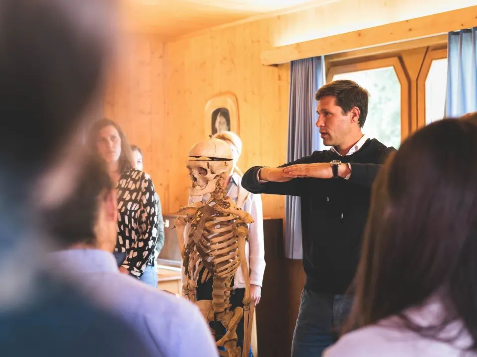 Homme expliquant devant un squelette lors d'un atelier